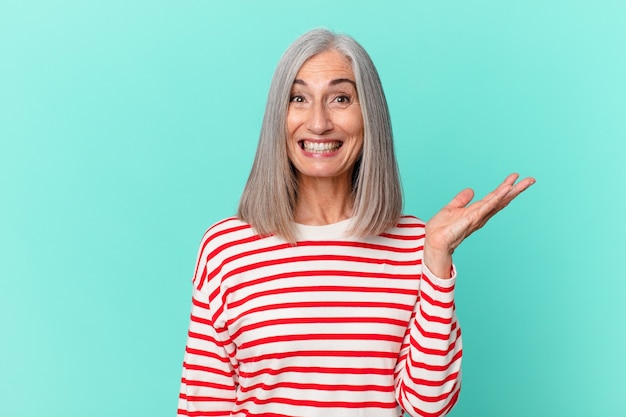 Middle age white hair woman feeling happy, surprised realizing a solution or idea