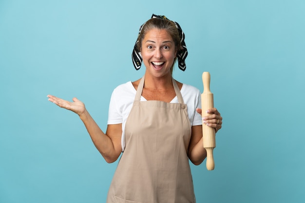 Middle age woman in chef uniform with shocked facial expression