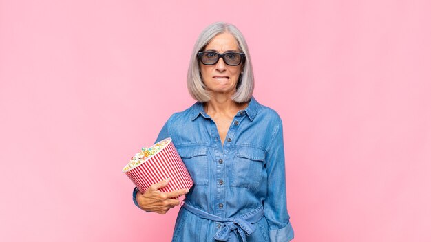 Middle age woman looking puzzled and confused, biting lip with a nervous gesture, not knowing the answer to the problem movie concept