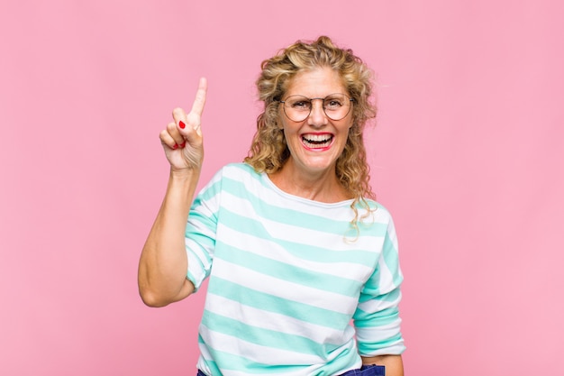 Middle age woman smiling cheerfully and happily