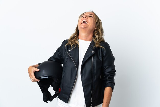 Middle aged biker over isolated white background laughing in lateral position