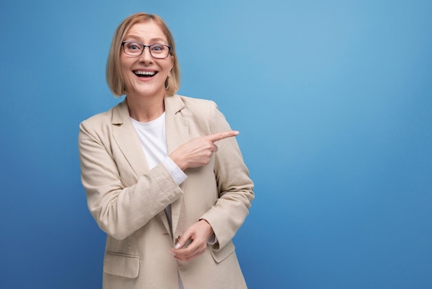 Middle aged business woman showing hand gesture on bright studio background with copy space