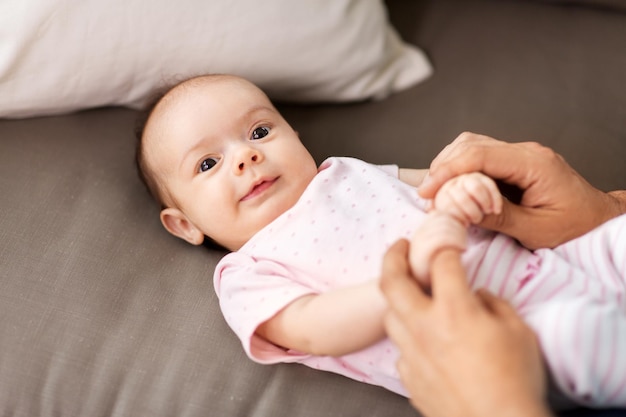 middle aged father playing with baby at home