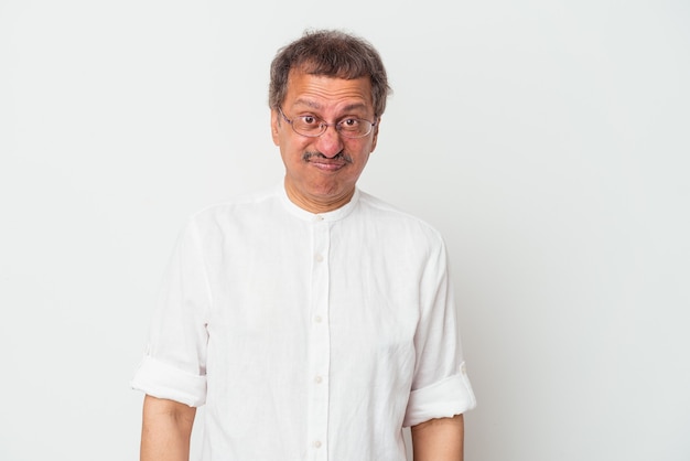 Middle aged indian man isolated on white background blows cheeks, has tired expression. Facial expression concept.