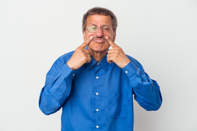 Middle aged indian man isolated on white background crying, unhappy with something, agony and confusion concept.