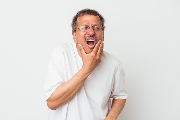 Middle aged indian man isolated on white background having a strong teeth pain, molar ache.