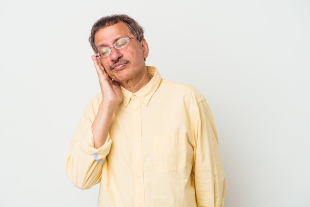 Middle aged indian man isolated on white background who is bored, fatigued and need a relax day.