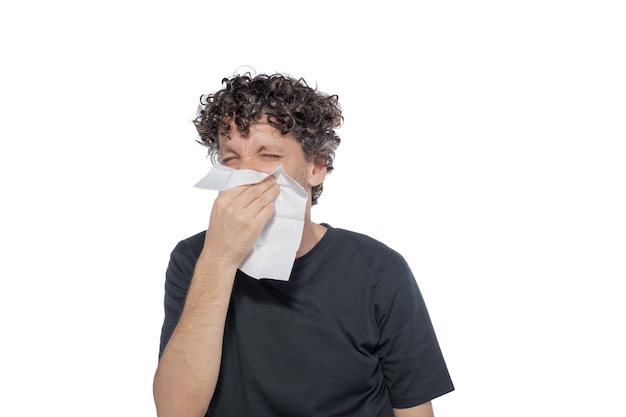 Middle aged man blowing his nose with tissue isolated on white background Concept of cold