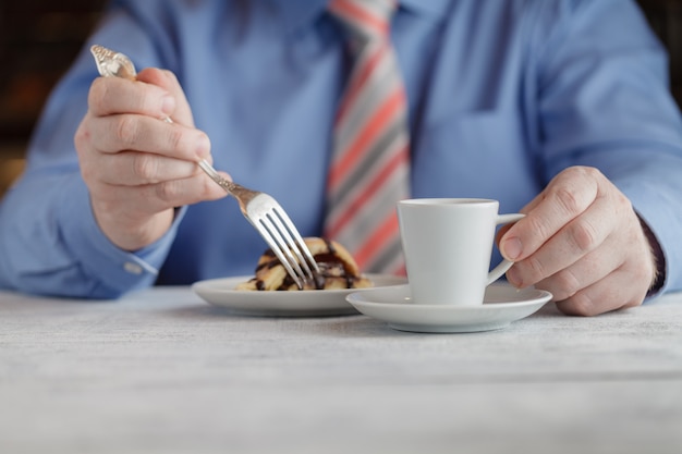 Middle Aged Man Eating Cheesecake