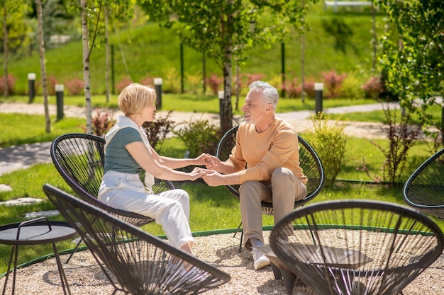 Middle-aged man and his wife holding hands