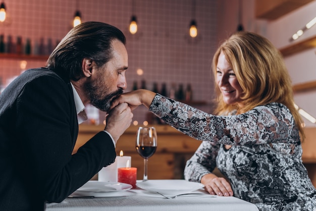 A middle-aged man and woman are dining in a restaurant