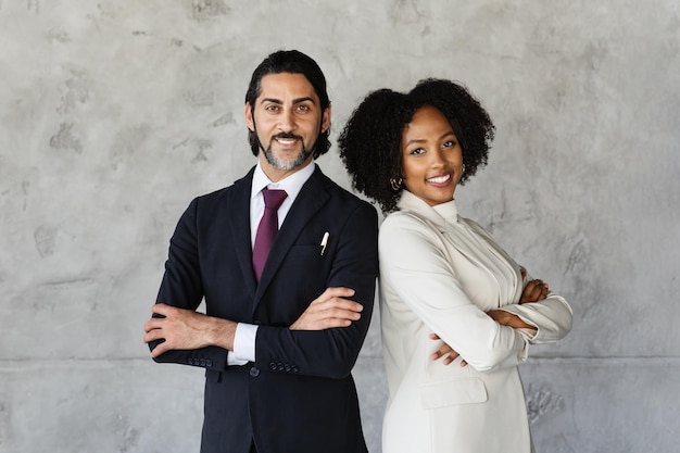 Middle aged man young black woman standing back to back