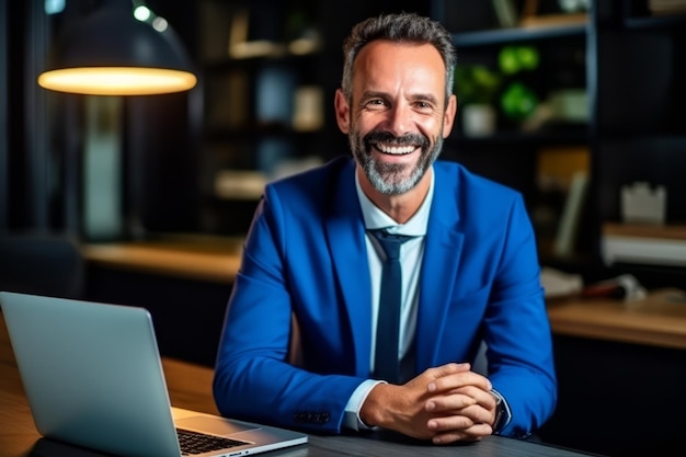 Middle aged professional business man wearing blue suit sitting at desk in office working on laptop