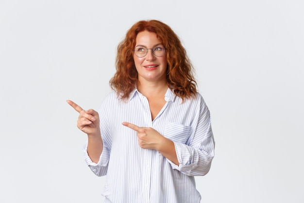 Middle-aged redhead woman posing