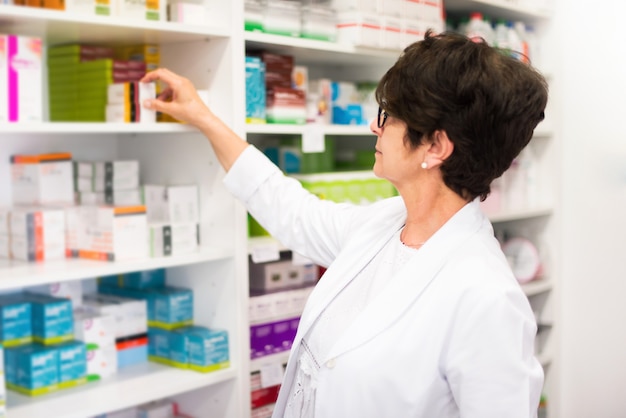 Middle-aged woman customer in the pharmacy looking for medications