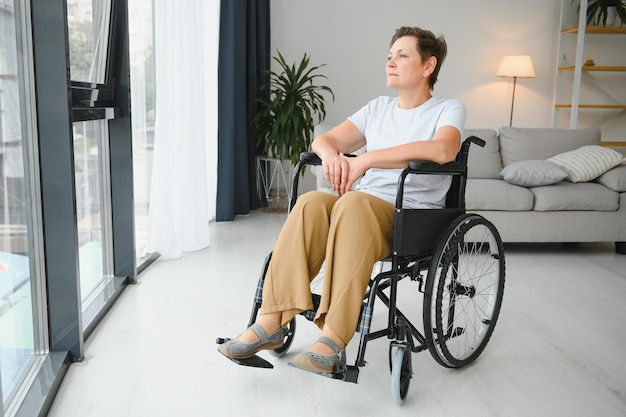 Middle aged woman sitting on wheelchair