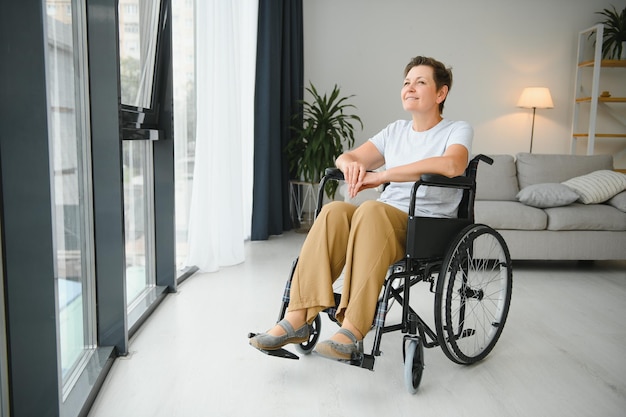 Middle aged woman sitting on wheelchair