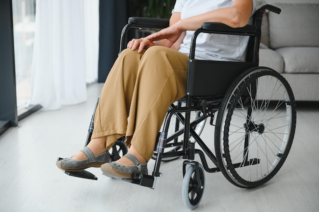 Middle aged woman sitting on wheelchair