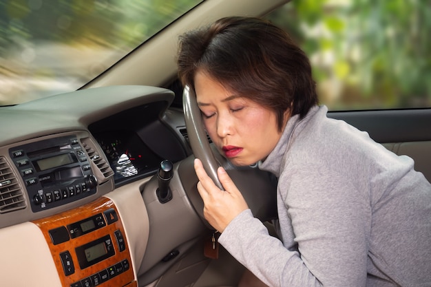 Middle Asian adult sleepy behind steering wheel. risk in transport accident.