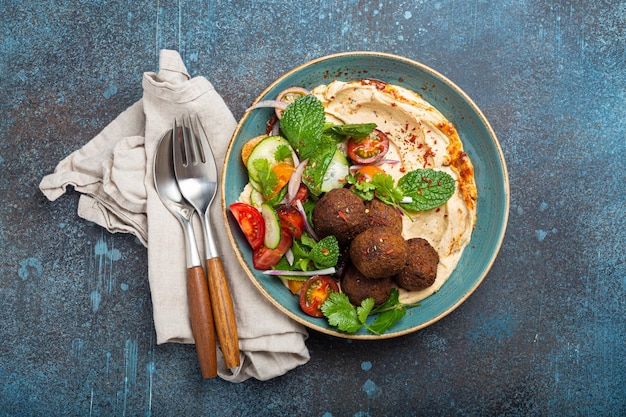 Middle Eastern Arab meal with fried falafel hummus vegetables salad