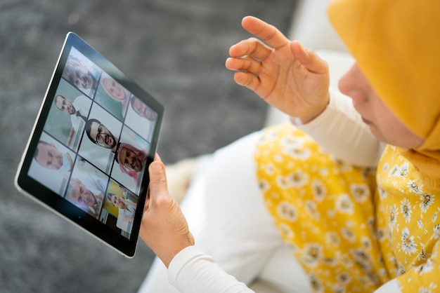 Middle Eastern businesswoman having online conference on tablet