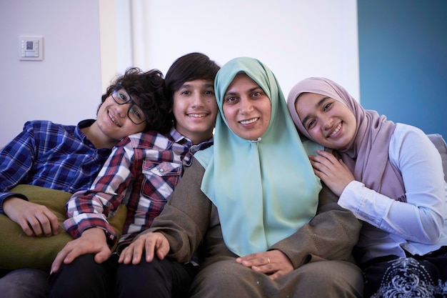 middle eastern family portrait single mother with teenage kids at home in living room