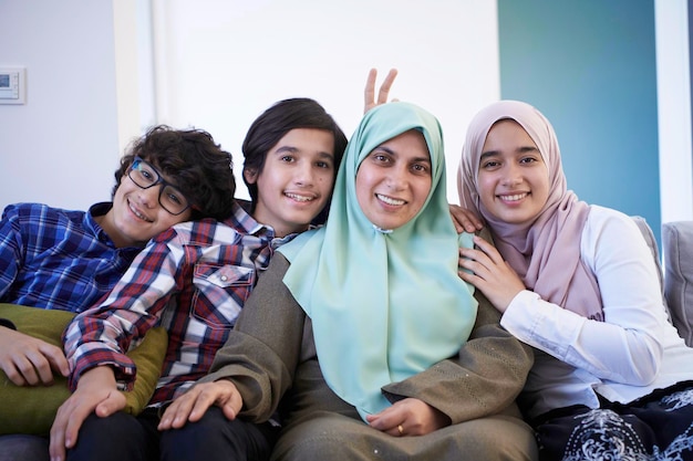 middle eastern family portrait single mother with teenage kids at home in living room