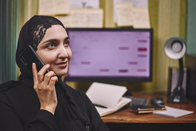 Middle eastern female entrepreneur. Busy Arabian businesswoman. woman in traditional Arabian clothing hijab or abaya working on PC