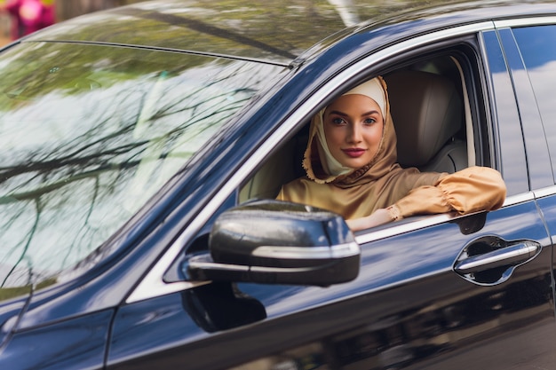 Middle eastern woman driving a car looking forward