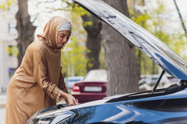 Middle eastern woman driving a car looking forward