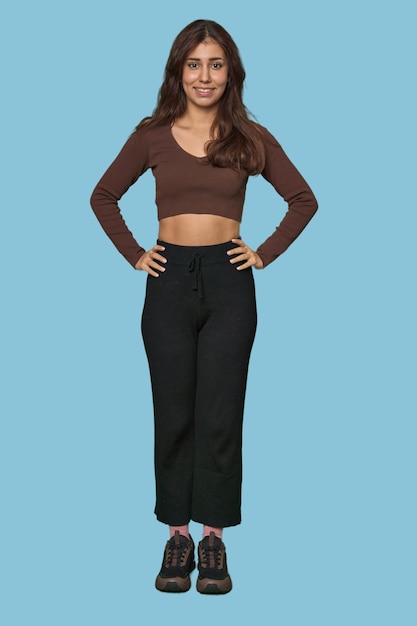 Middle Eastern woman full body studio confident keeping hands on hips