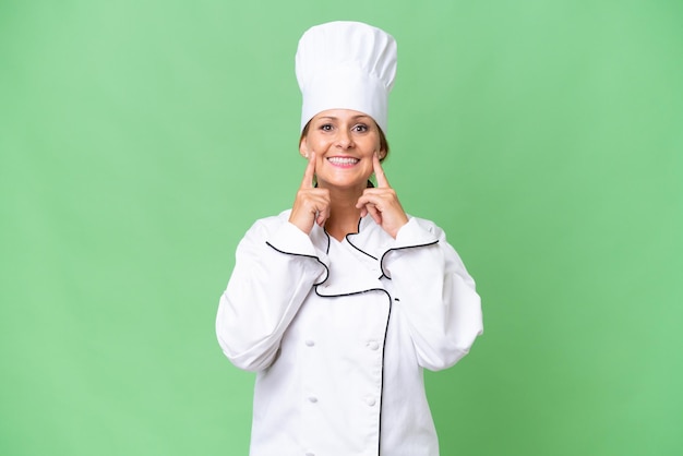 Middleaged chef woman over isolated background smiling with a happy and pleasant expression