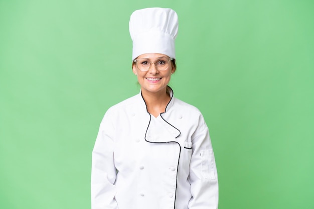 Middleaged chef woman over isolated background with glasses and happy