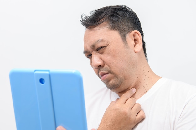 Middleaged mam point to his skin on neck