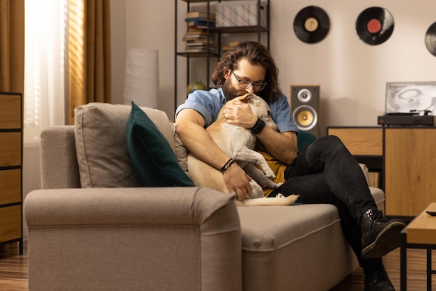 A middleaged man hugs his dog after returning from work a dog owner greets his pet after returning f