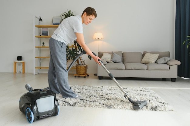 Middleaged woman cleaning new apartment