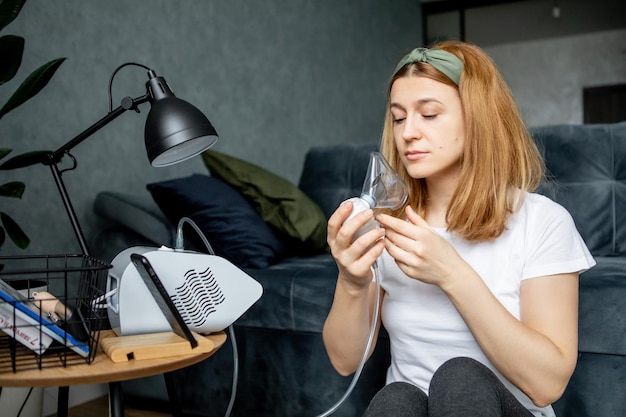 middleaged woman makes inhalation at home Cold respiratory diseases Influenza and viral infection