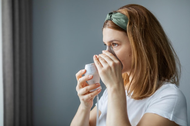 middleaged woman makes inhalation at home Cold respiratory diseases Influenza and viral infection