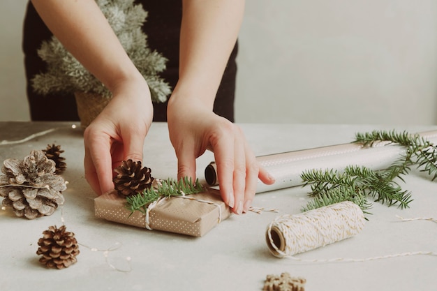 Middleaged woman packing gifts for the Christmas holidays