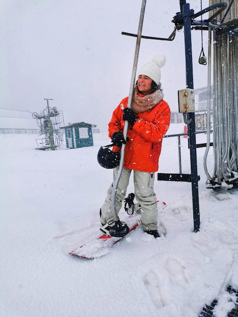 Middleaged woman snowboarding on a ski slope