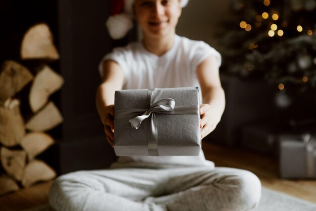 Photo midsection of boys holding gift box sitting at home