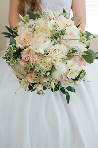 Midsection of bride holding bouquet