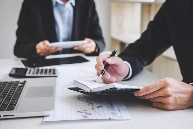 Midsection of business colleagues working at desk in office