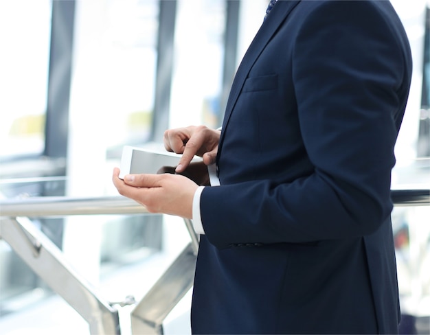 Midsection of businessman using digital tablet in office