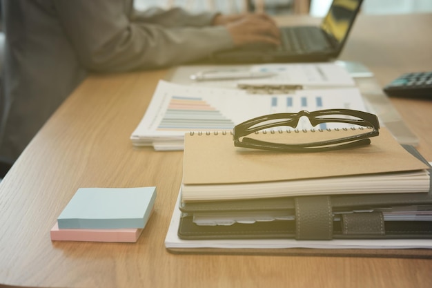 Midsection of businesswoman working on table