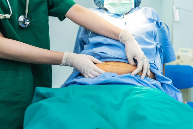 Photo midsection of doctor examining patient in hospital