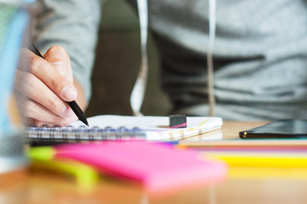 Photo midsection of fashion designer making sketch on table in office