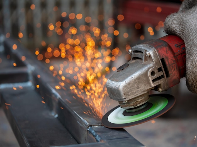 Midsection of man cutting metal