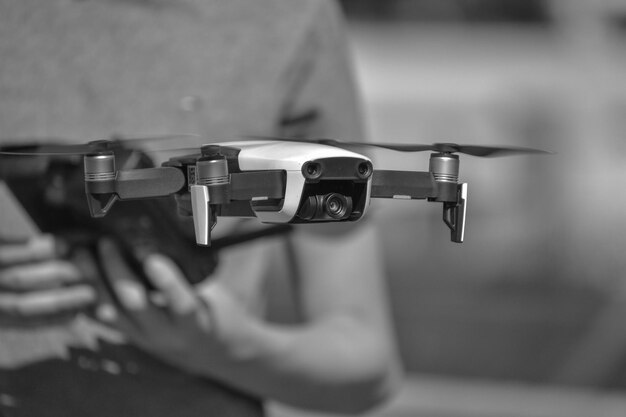 Photo midsection of man holding drone outdoors