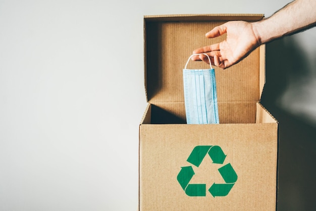 Photo midsection of man holding paper box against white background